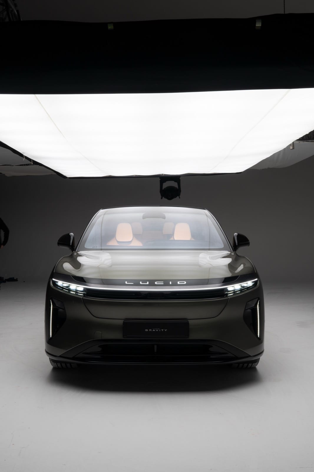 On-set frontal view of the Lucid Gravity beneath overhead diffusion, documenting the studio lighting environment.