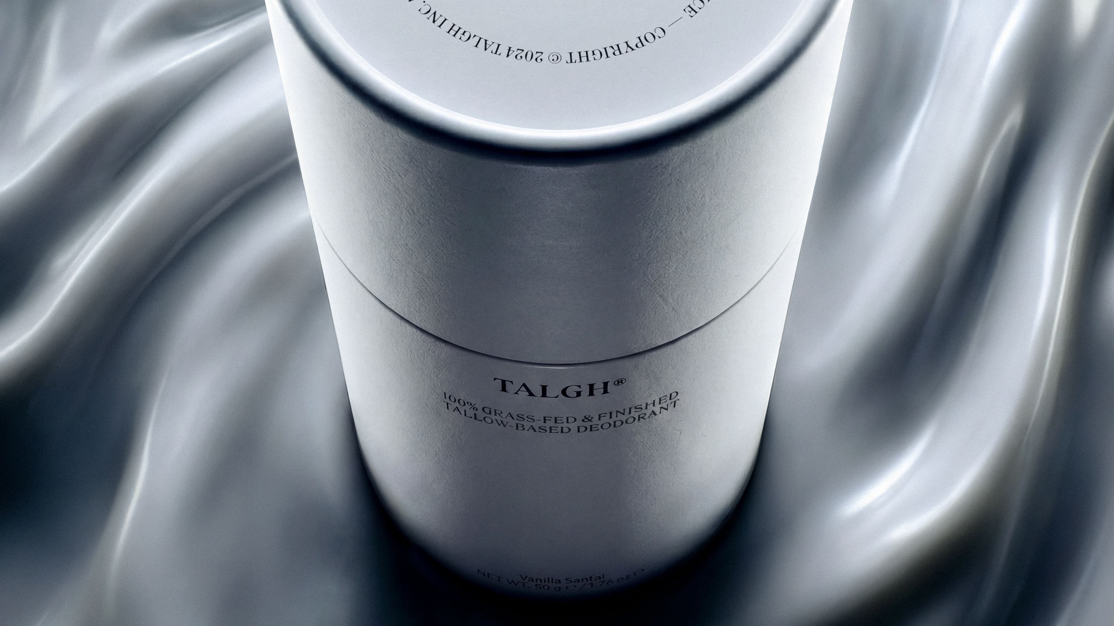 Talgh Essential Deodorant resting diagonally within a sculptural silver cream-like surface inspired by its vanilla and sandalwood notes.