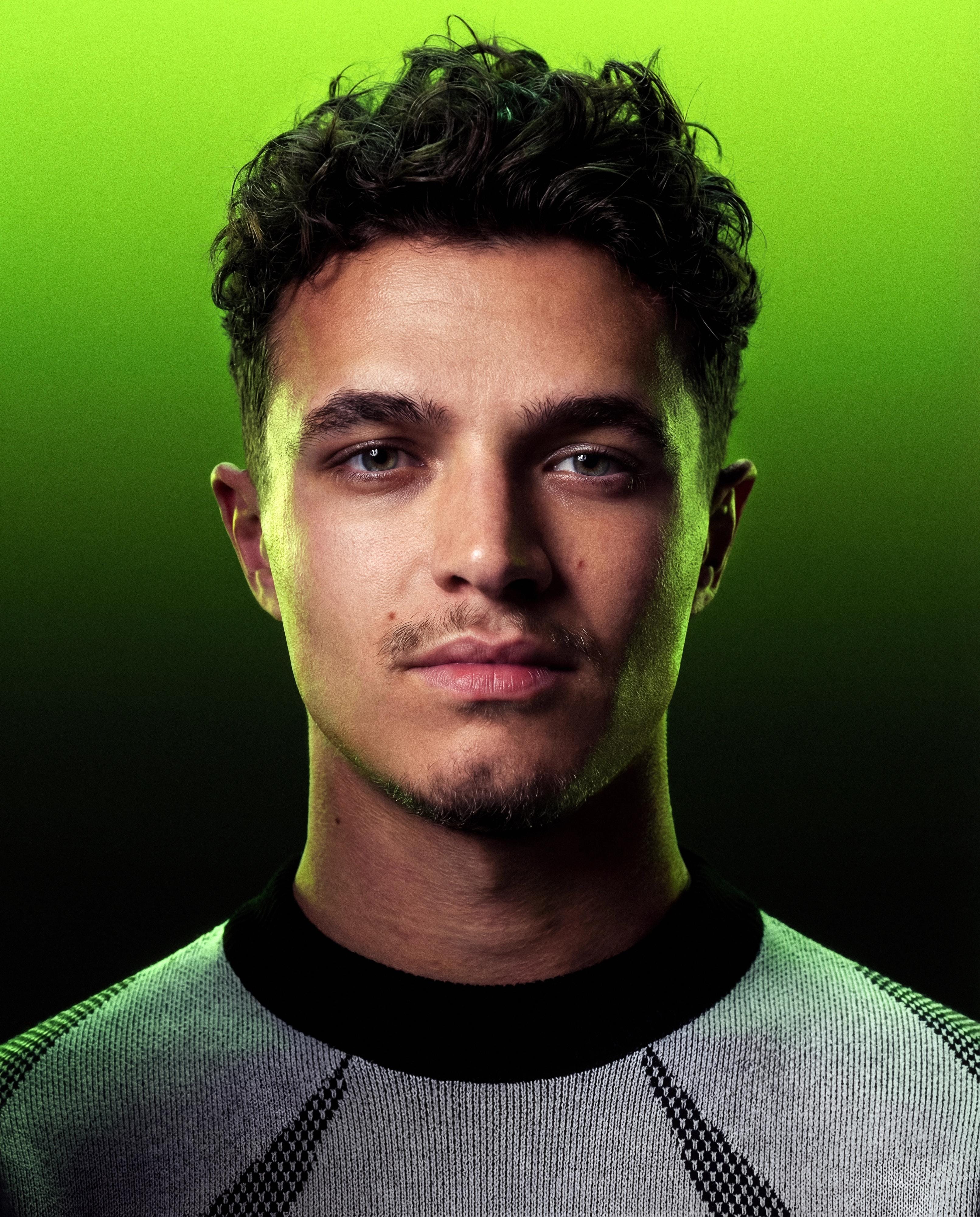 Tight studio portrait of Lando Norris against an acid-green gradient.