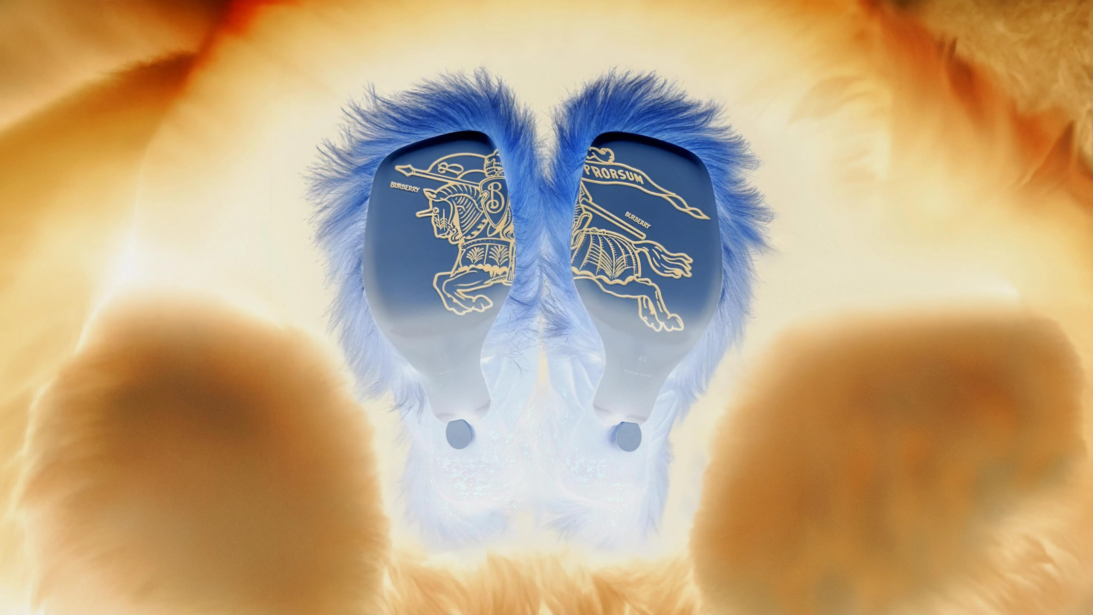 Solarised gold-and-cobalt view of furry hoof-like forms with Burberry Equestrian Knight marks on their soles.