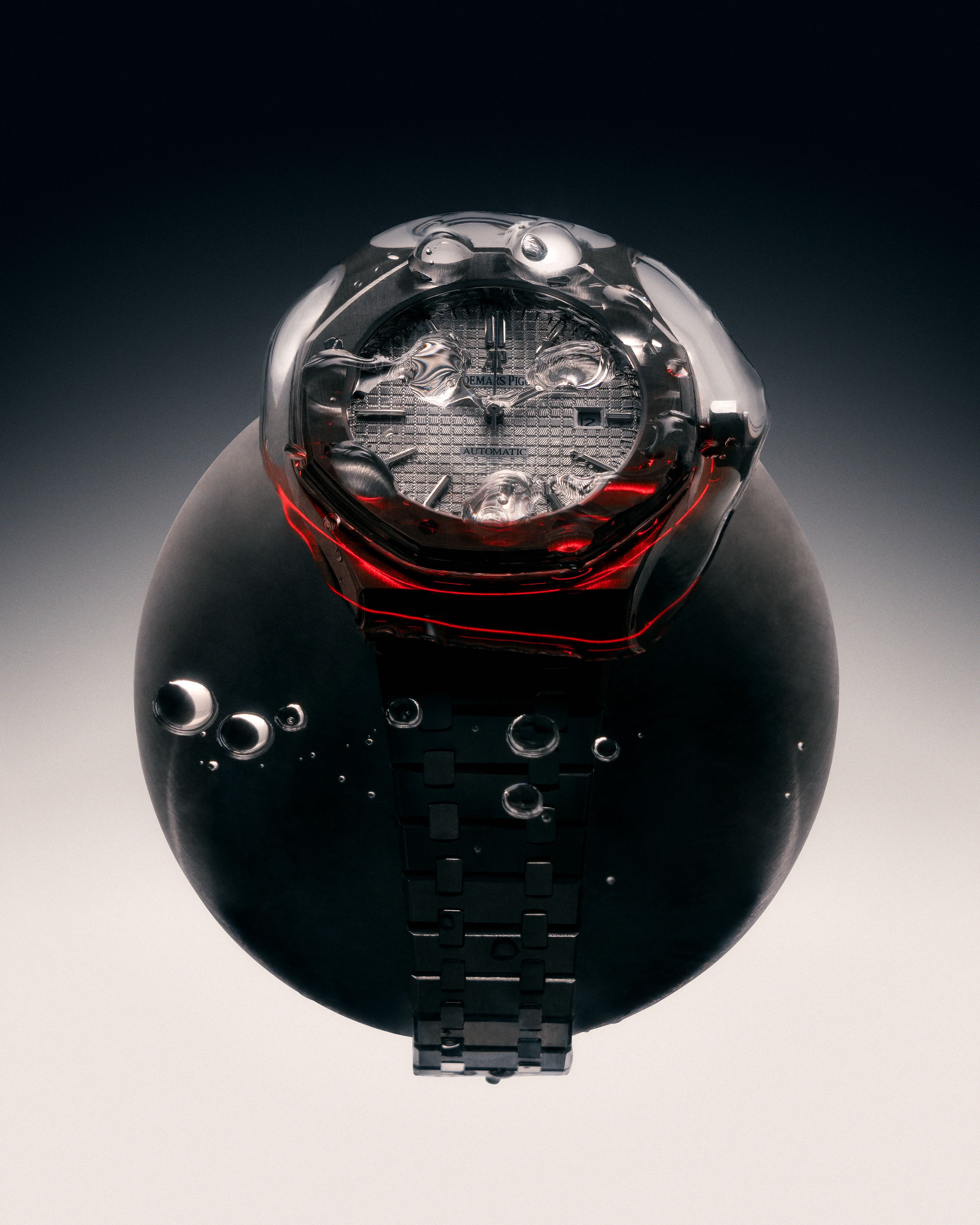 Audemars Piguet watch seen through a dark transparent dome with deep red light gathering around its case.