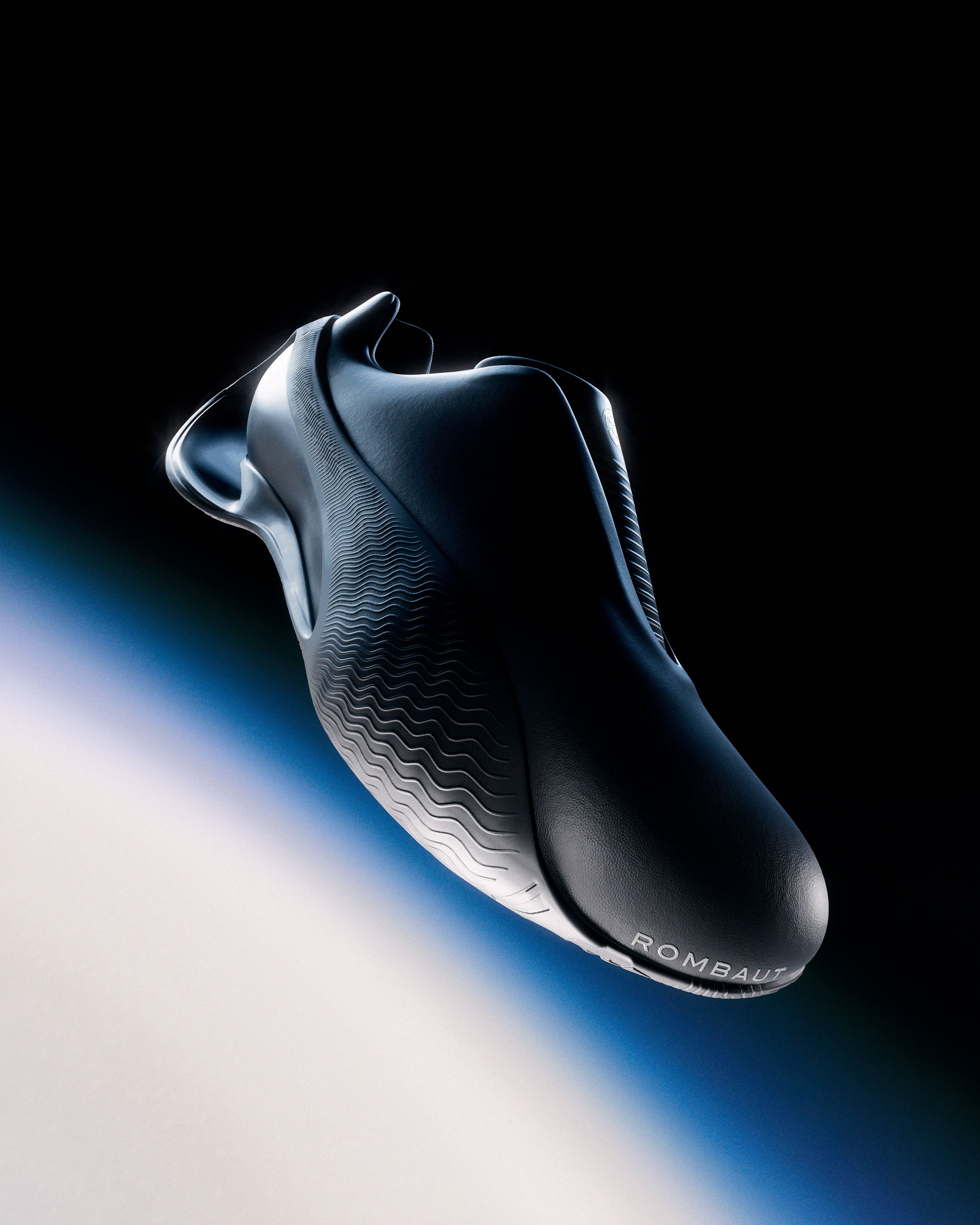 Black Rombaut × Puma Levitation sneaker floating above a diagonal field of blue-white light.